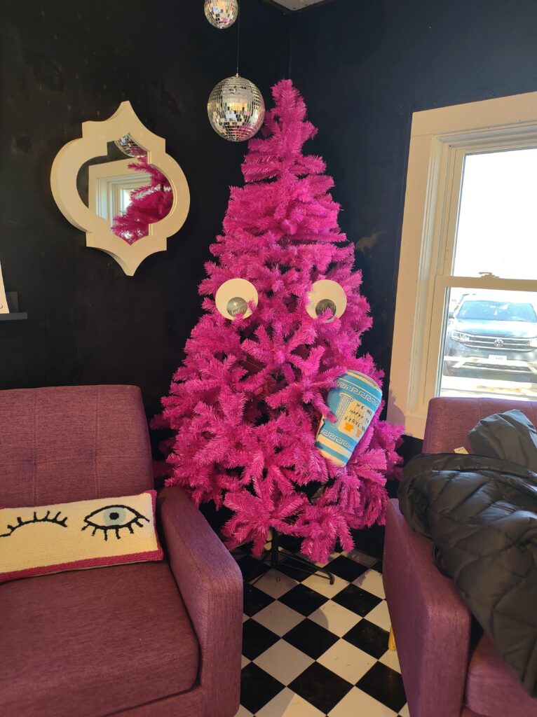 A pink tree watches people at The Eyeglass Lass in Olde Mystick Village