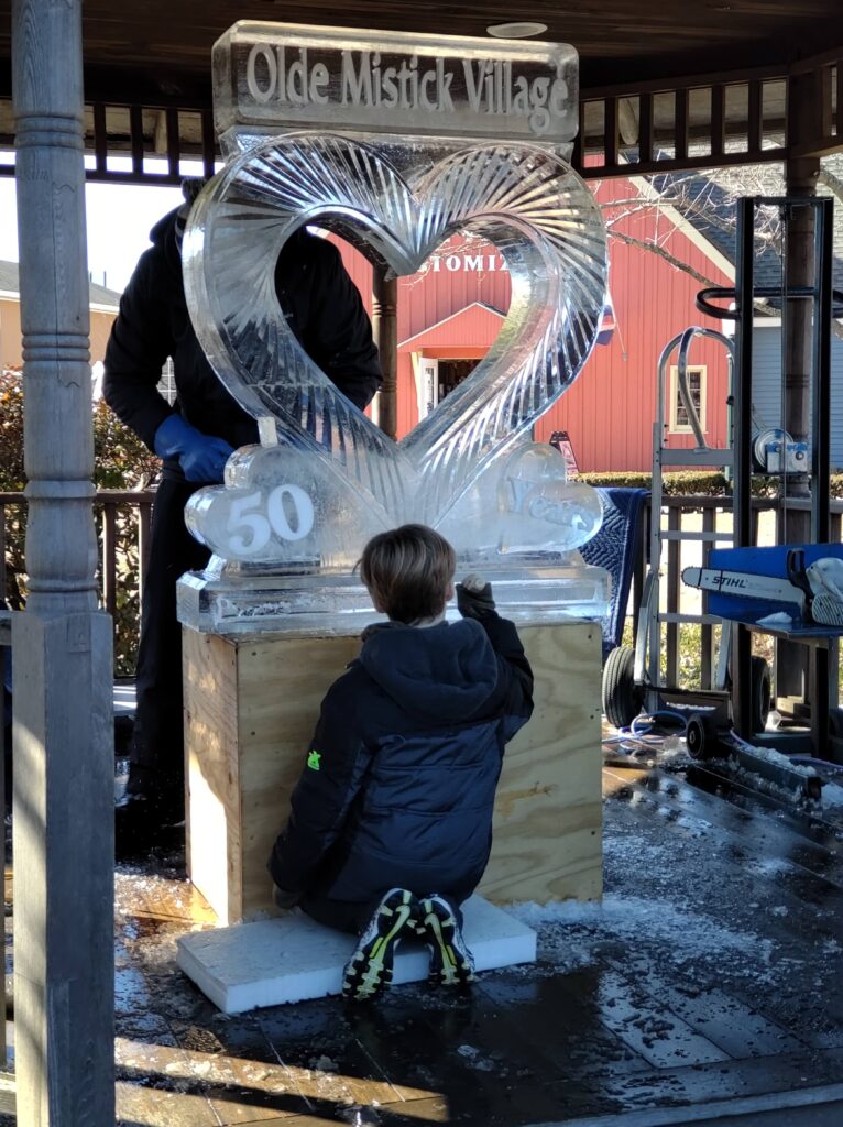 A father and son team create an ice sculpture for Olde Mystick Village