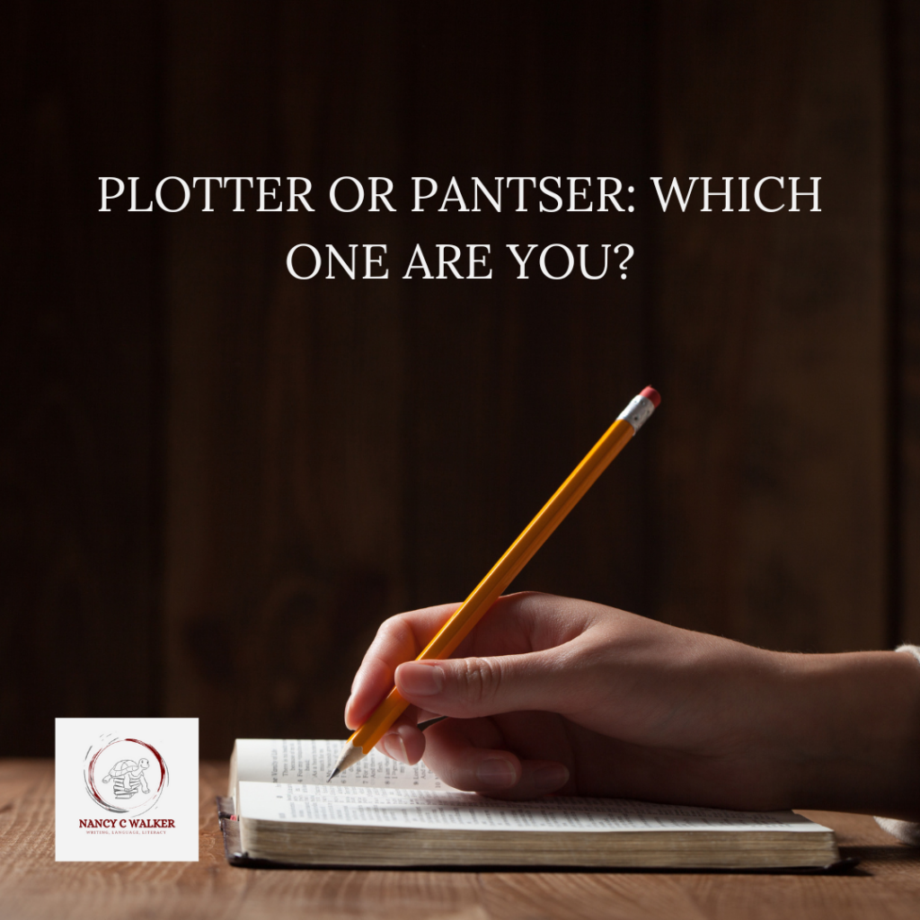 In front of a black wall, a book is open on a table. A hand holds a pencil as if to write in the book. The words "Plotter or Pantser: Which one are you?" are near the top of the image, above the hand.