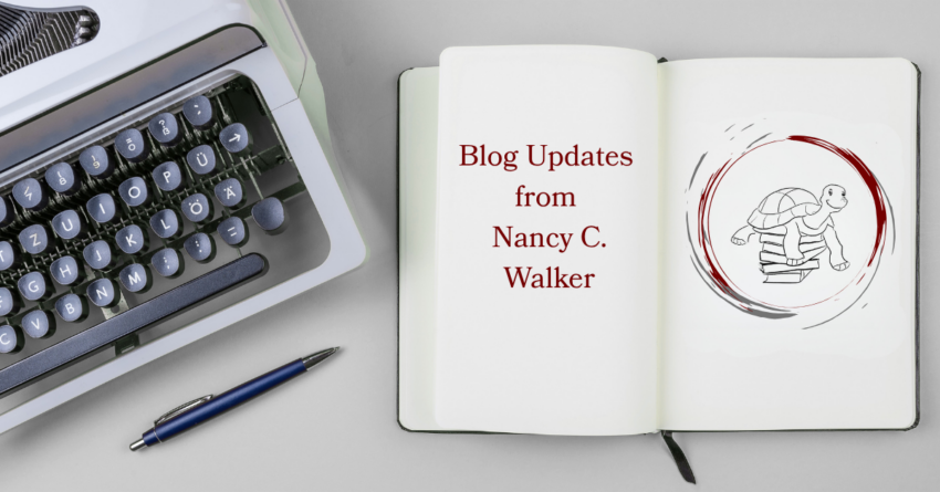 An open books reads "Blog Updates from Nancy C. Walker" on one page and Nancy's logo of a turtle on a stack of books on the other. A typewriter is to left of the book, partially out of the frame. A pen lays in front of the typewriter.